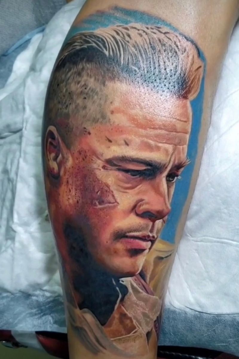 Realistic color portrait tattoo of a man with swept-back hair by Frank Tattoo Arts