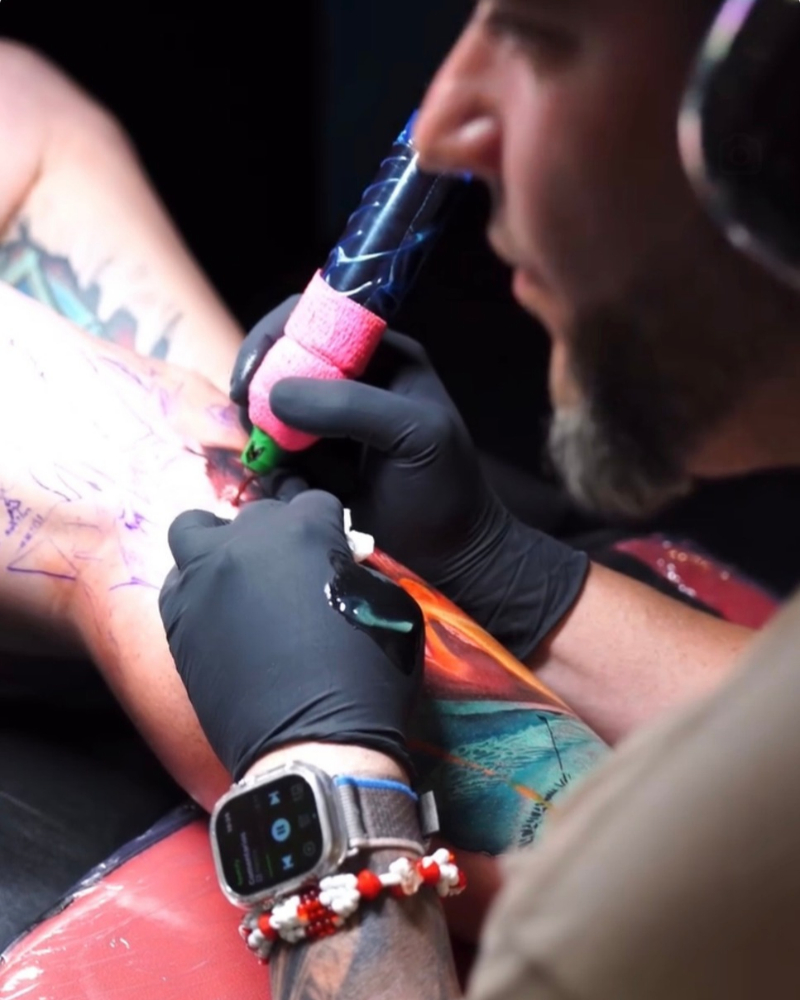 Frank working on a client's tattoo