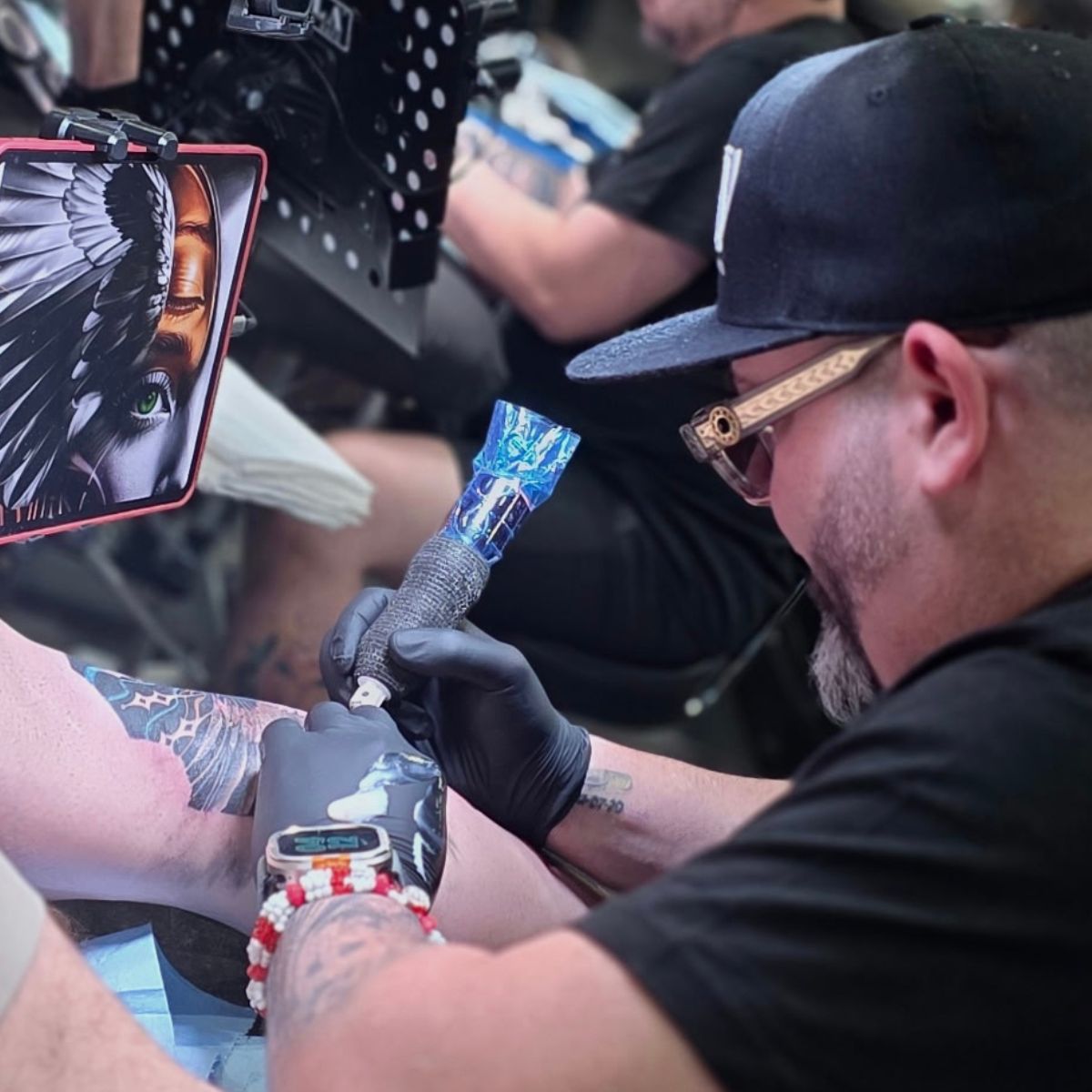 Frank working on the calf tattoo during Table Rock Tattoo Convention 2026 in Branson, Missouri.