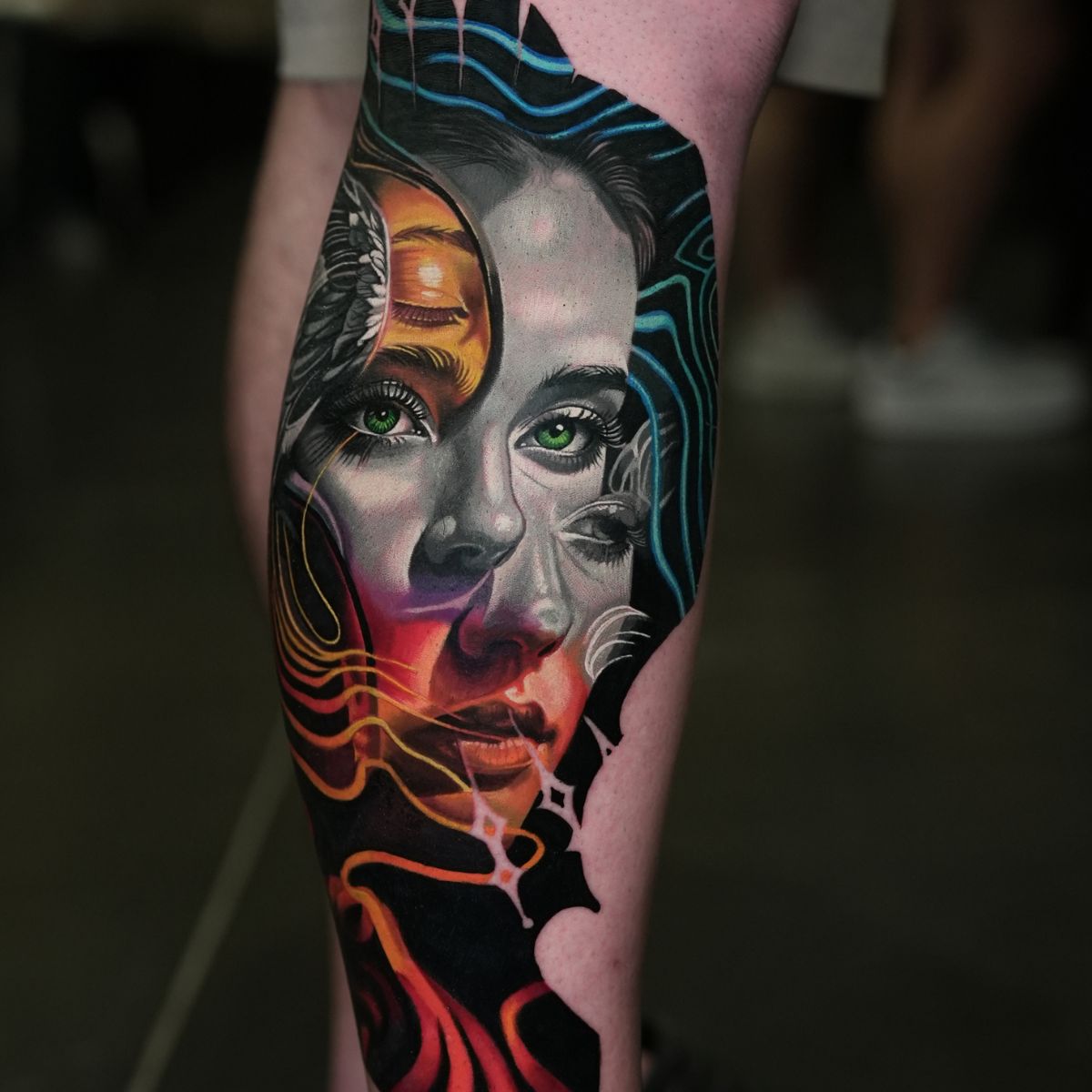 Detail of the portrait, contrasting shading and flowing colored lines in Frank’s calf tattoo.