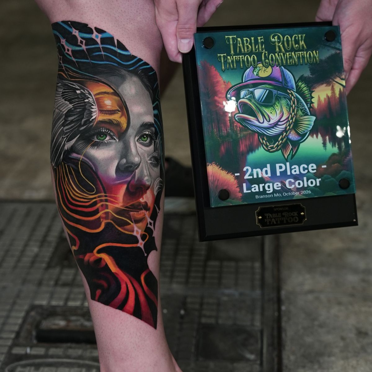 Frank’s calf tattoo beside the 2nd Place Large Color award at Table Rock Tattoo Convention 2026.